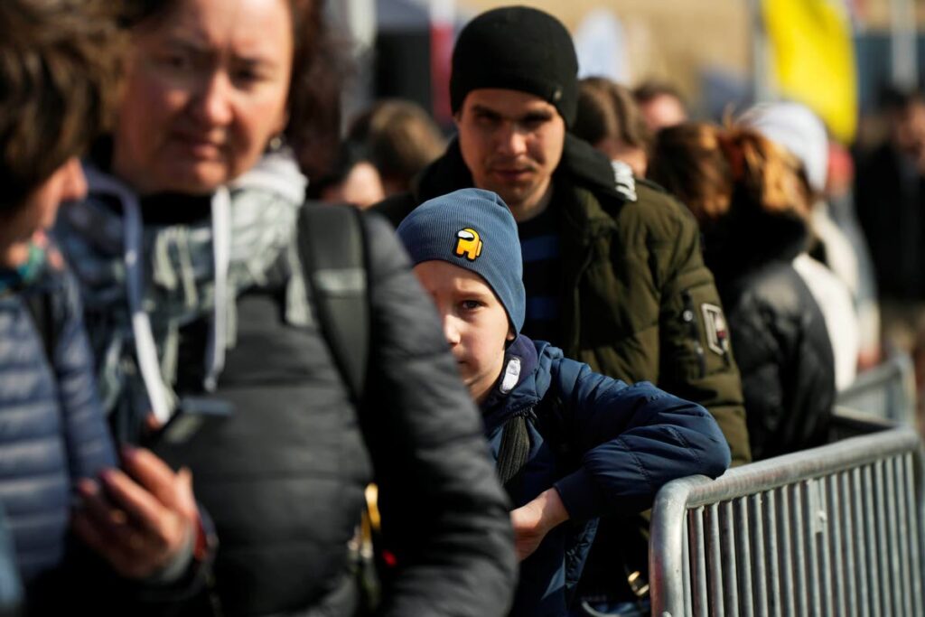 Refugees wait for transport after fleeing the war from neighbouring Ukraine at the border crossing in Medyka, southeastern Poland, on Saturday. - AP Photo