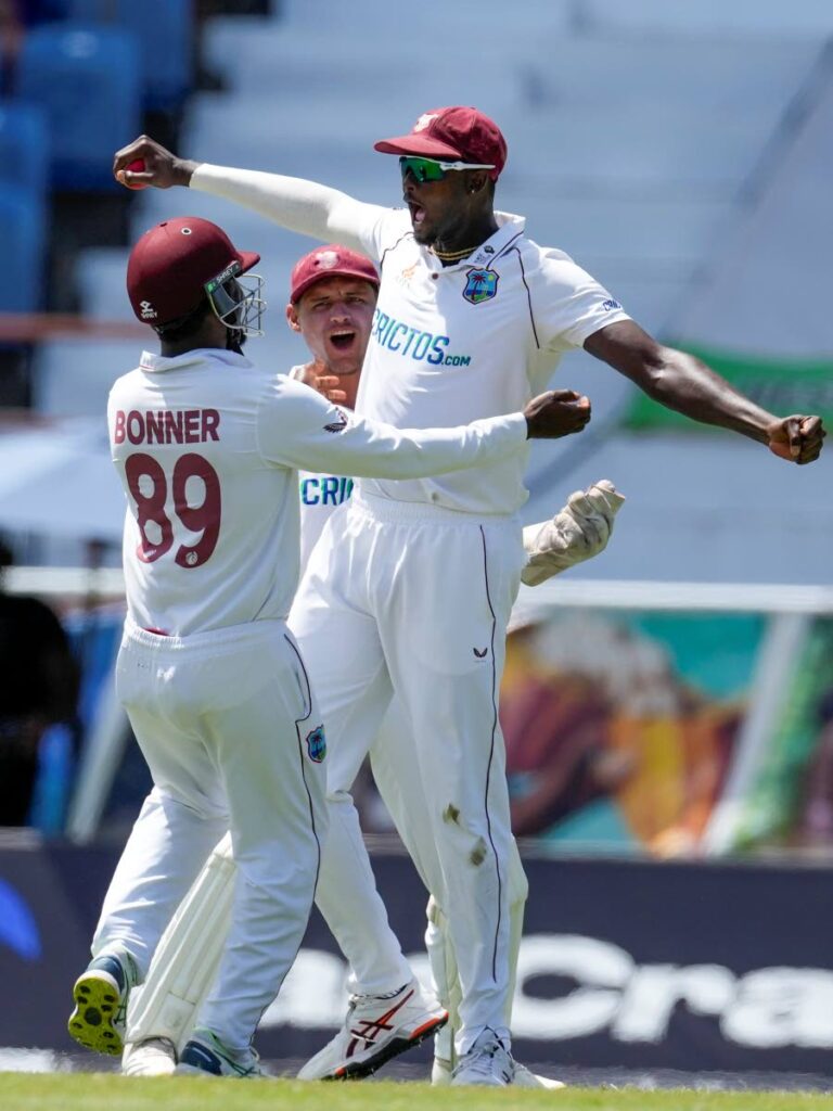 West Indies' Jason Holder celebrates taking the catch to dismiss England's Chris Woakes during day four of their third Test match at the National Cricket Stadium in St. George's, Grenada, on Sunday. (AP PHOTO) 