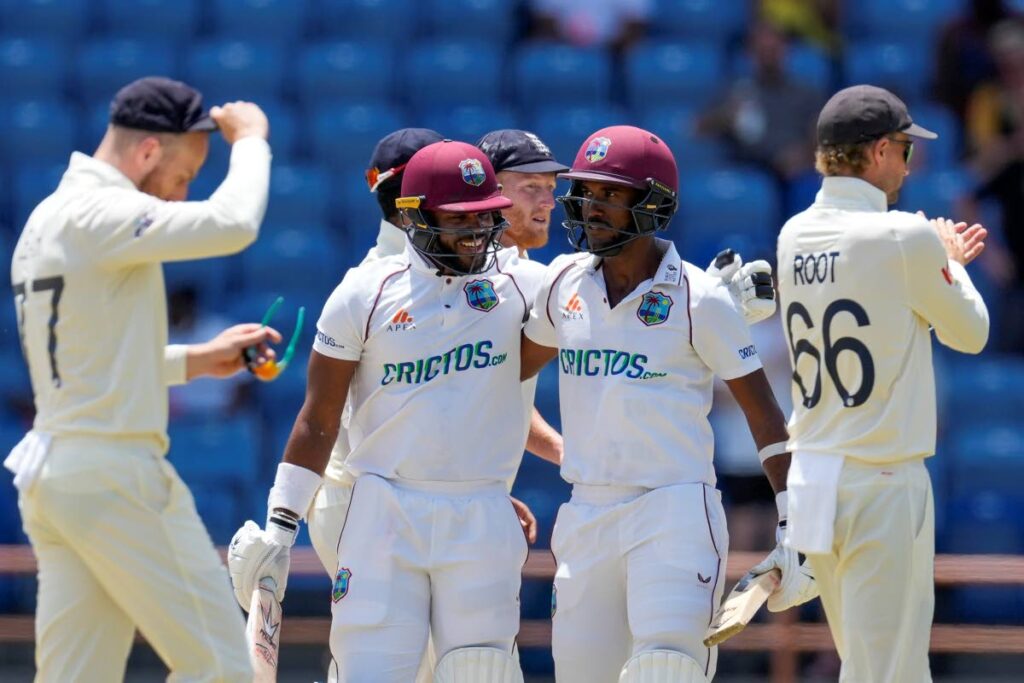 West Indies’ captain Kraigg Brathwaite, right, and John Campbell celebrate defeating England by ten wickets on day four of their third Test match at the National Cricket Stadium in St. George’s, Grenada, on Sunday. AP Photo - 