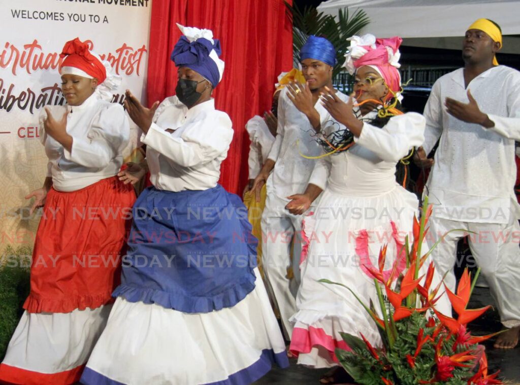 Members of the North West Laventille Cultural Performers dance during the Spiritual Baptist Shouter Liberation Day celebrations at the HDC Village Plaza car park, Phase 2 La Horquetta on March 28. - 