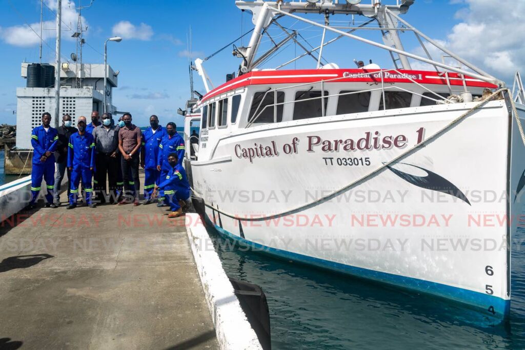 Chief Secretary Farley Augustine and Assistant Secretary of Food Security, Natural Resources, The Environment and Sustainable Development Nigel Taitt join the crew of Capital of Paradise 1, at the Scarborough Port, Tuesday. - David Reid