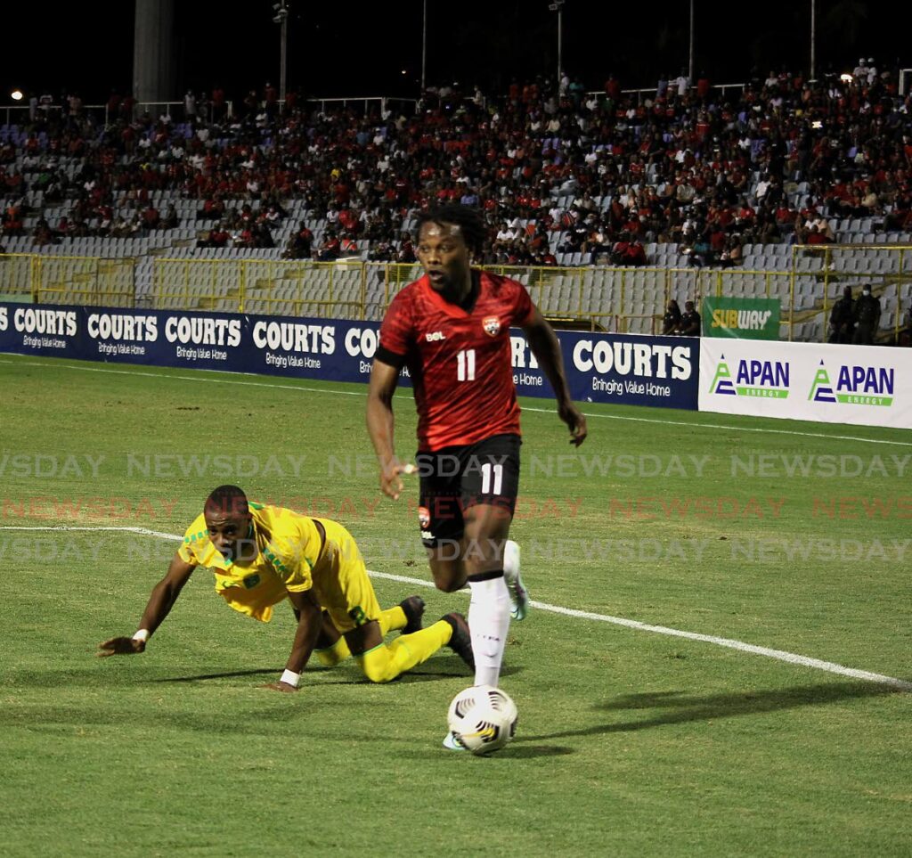 TT’s Levi Garcia(R) evades a Guyanese defender during the final match of the Courts Caribbean Classic tri-nation series, held at the Hasely Crawford Stadium, Port of Spain. The match ended 1-1. - ROGER JACOB