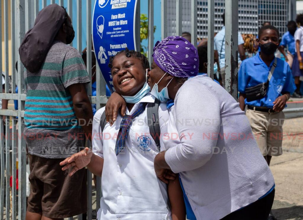 A KISS FOR YOU: Alicia De Leancey, 12, gets a kiss from her mother Amani Mc Kenna outside the Scarborough Methodist Primary School in Crown Point, Tobago. File photo by David Reid  -