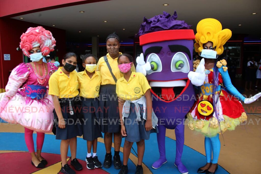 SEA students  of Bryan Mawr  Primary School celebrating with costumed characters at Movie Towne. PHOTO BY SUREASH CHOLAI