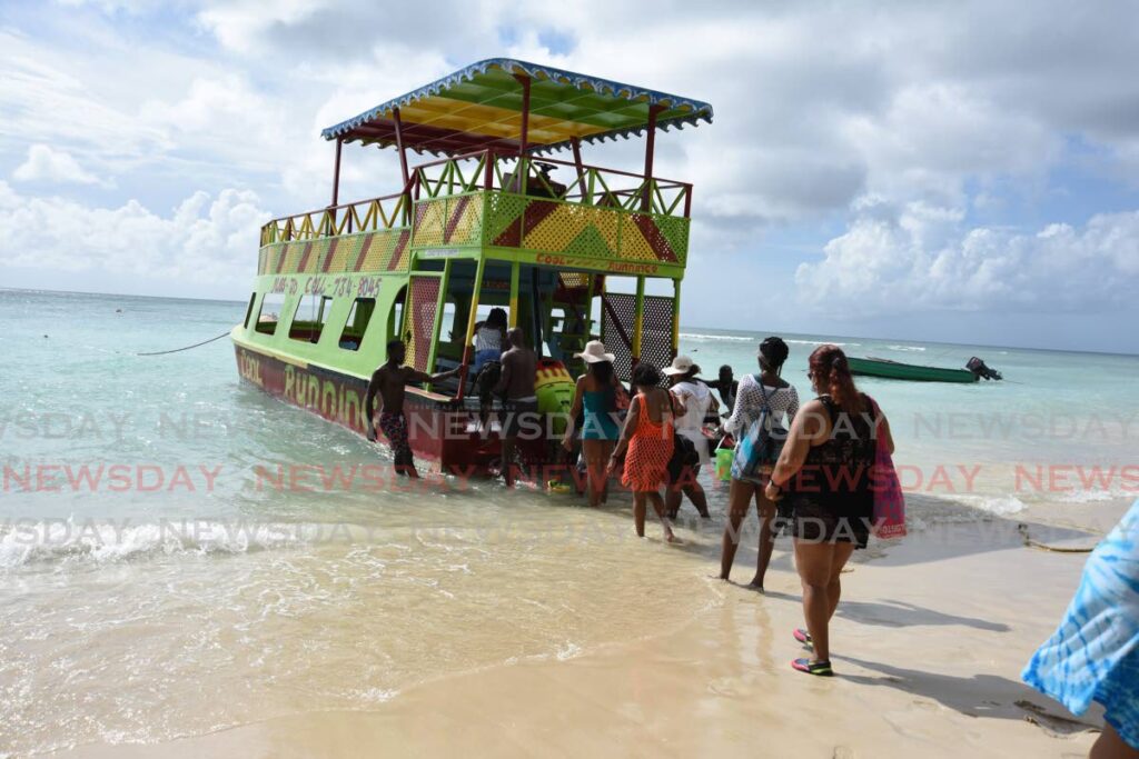 Passengers board Cool Runnings at Pigeon Point to tour Buccoo Reef in Tobago.  File photo/Ayanna Kinsale 