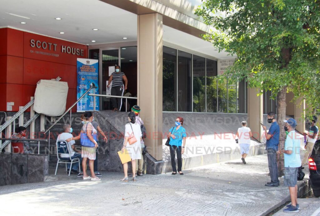 In this January 2021 file photo members of the public use a Sunday opening of the Elections and Boundaries Commission head office on Frederick Street, Port of Spain to renew their national identification cards. - PHOTO BY ROGER JACOB