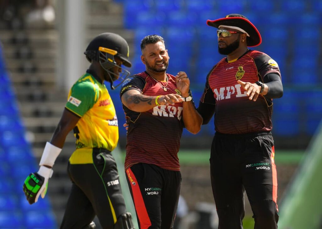 Trinbago Knight Riders captain Kieron Pollard, right, and Ravi Rampaul celebrate a wicket against Jamaica Tallawahs in the 2021 Hero Caribbean Premier League at Warner Park Sporting Complex in Basseterre, St Kitts. PHOTO COURTESY CPL T20 - 