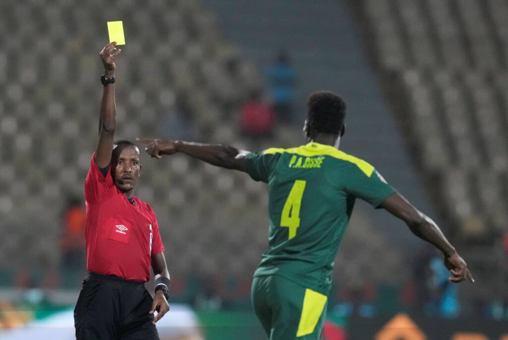 In this Feb 2, 2022 file photo, referee Bamlak Tessema of Ethiopia, left, shows a yellow card to Senegal’s Pape Abou Cisse during the African Cup of Nations 2022 semi-final against Burkina Faso at the Ahmadou Ahidjo stadium in Yaounde, Cameroon. - AP