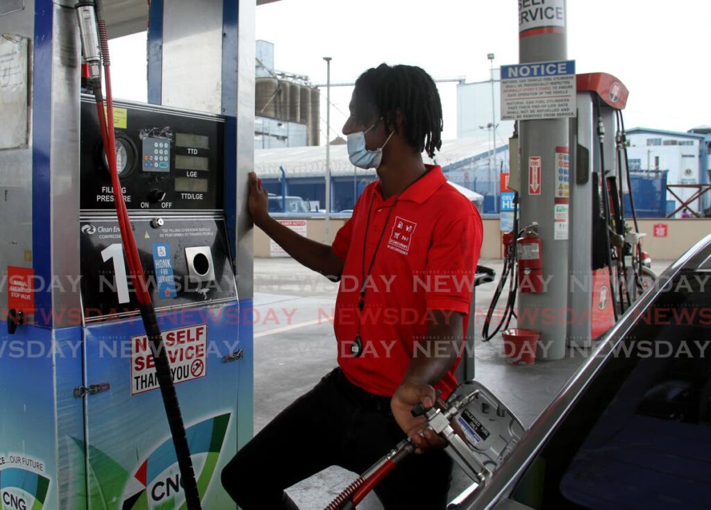 FILE PHOTO: CNG pump attendant Triston Marcelle fills up a car  at the St Christopher's Service Station, Wrightson Road, Port of Spain. - AYANNA KINSALE