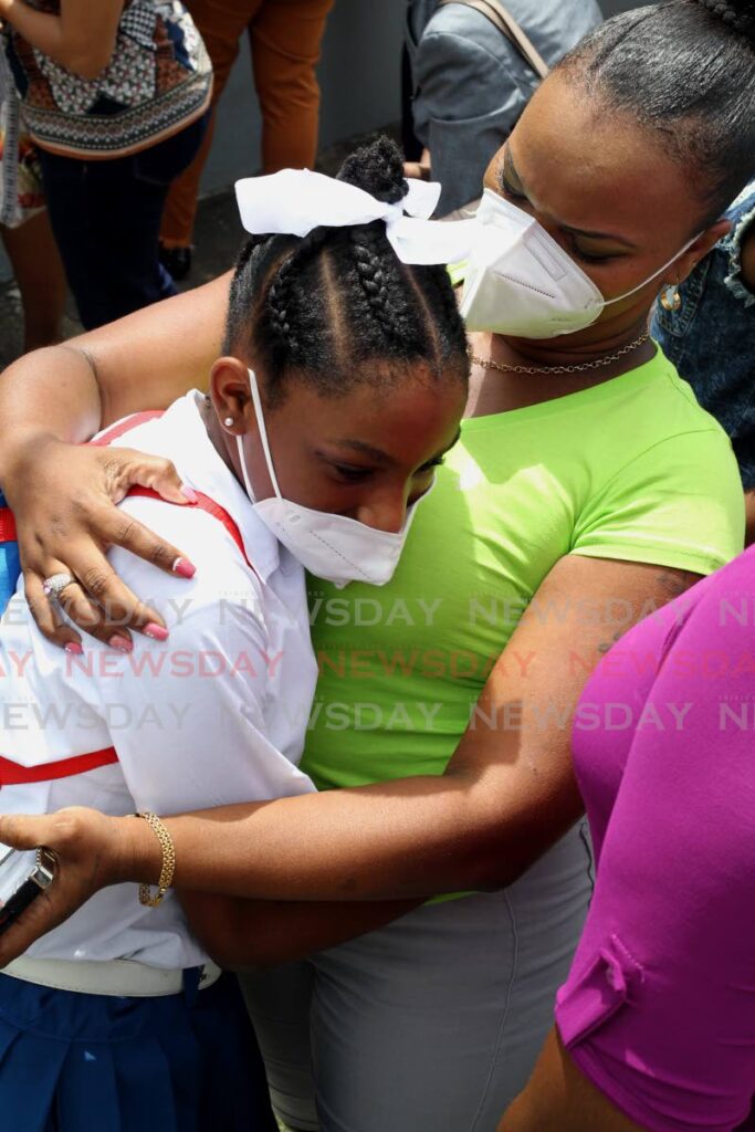A Sacred Heart Girls RC student is greeted by her mother after the SEA exam ended on Thursday. PHOTO BY ROGER JACOB - 