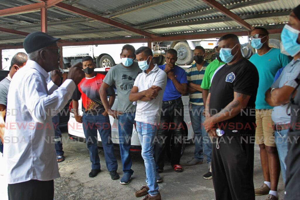 An NUGFW representative speaks with workers of the Ministry of Works’ Transport Division South at the district office in Penal on Monday. - Photo by Marvin Hamilton