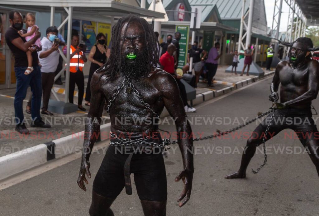 TIME TO PROWL AGAIN: With Tobago Carnival set for October 28-30, traditional mas characters such as these, seen at the ANR Robinson Airport awaiting the arrival of tourists from England, will once again prowl the streets during the reign of the Merry Monarch. FILE PHOTO   - 