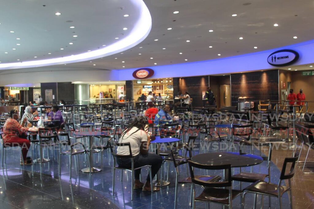SEA OF EMPTY SEATS: A handful of customers at the food court in Gulf City Mall on Monday, the first day of the lifting of safe zone restrictions. Photo by Marvin Hamilton