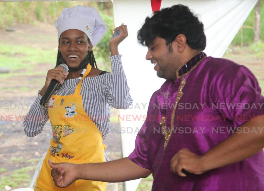 Sarah Hood dances with Keshav Sankar during the  No Youth Left Behind  Indian Arrival Day display celebration at  the Taste of Trinidad and Tobago cuisine and culture project held at the La Brea Pitch Lake. Photo by Lincoln Holder 