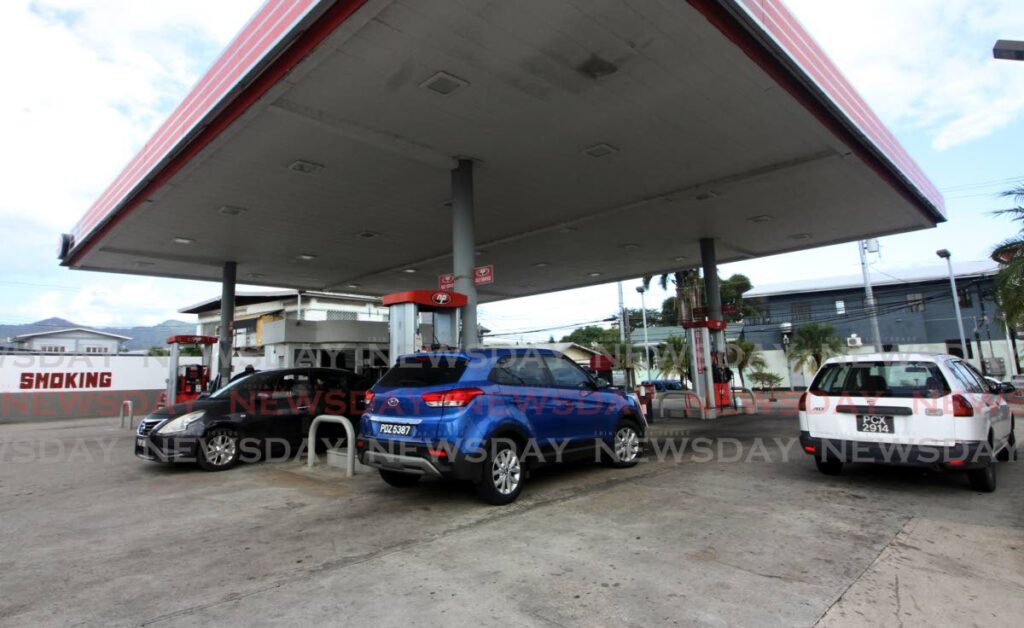 Drivers refuel their vehicles at the NP gas station off Wrightson Road in Port of Spain on Friday, the same day Finance Minister Colm Imbert announced an increase in the price of diesel, premium gas and super gas, effective April 19. PHOTO BY ANGELO MARCELLE - 