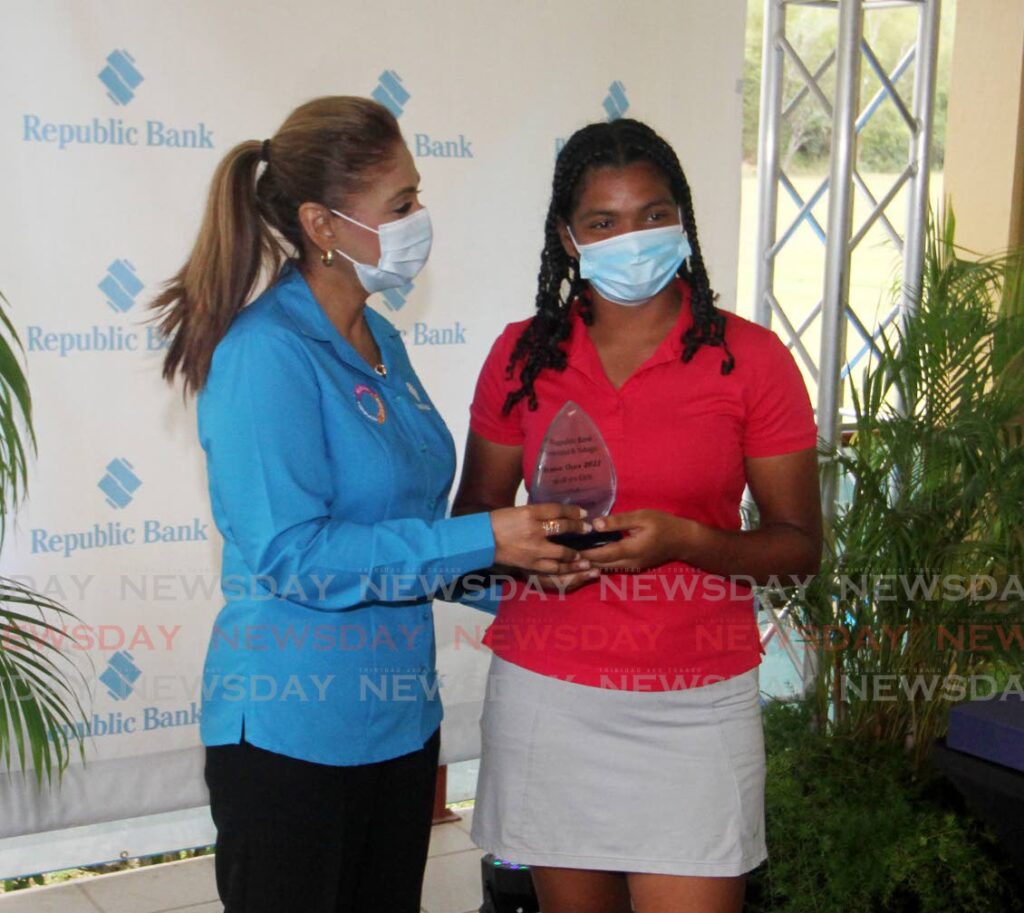 Jada Charles (right), collects her award from Republic Bank Shared Services Division General manager Carlene Seudat for winning the Girls 16-18 group, in the Republic Bank TT Junior Golf Tournament, at the Chaguaramas Golf Course on Friday. - Angelo Marcelle