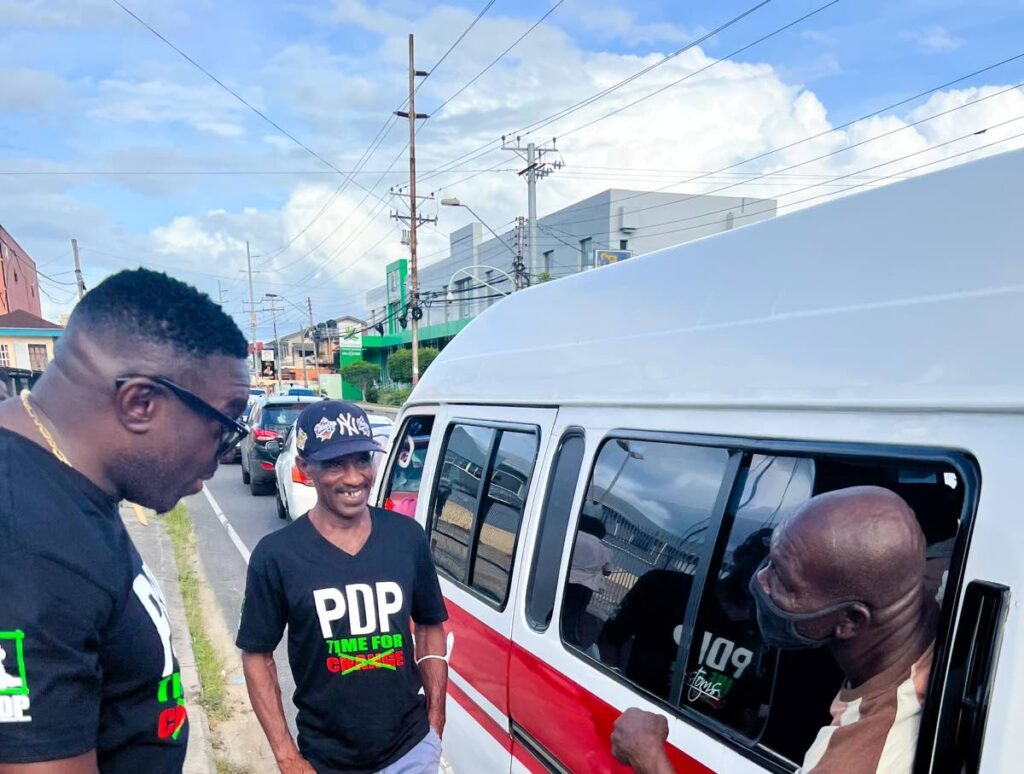 PDP political leader Watson Duke, left, during a walkabout in Barataria on March 31. He will launch the party's Trinidad headquarters on April 10.  - Photo courtesy PDP