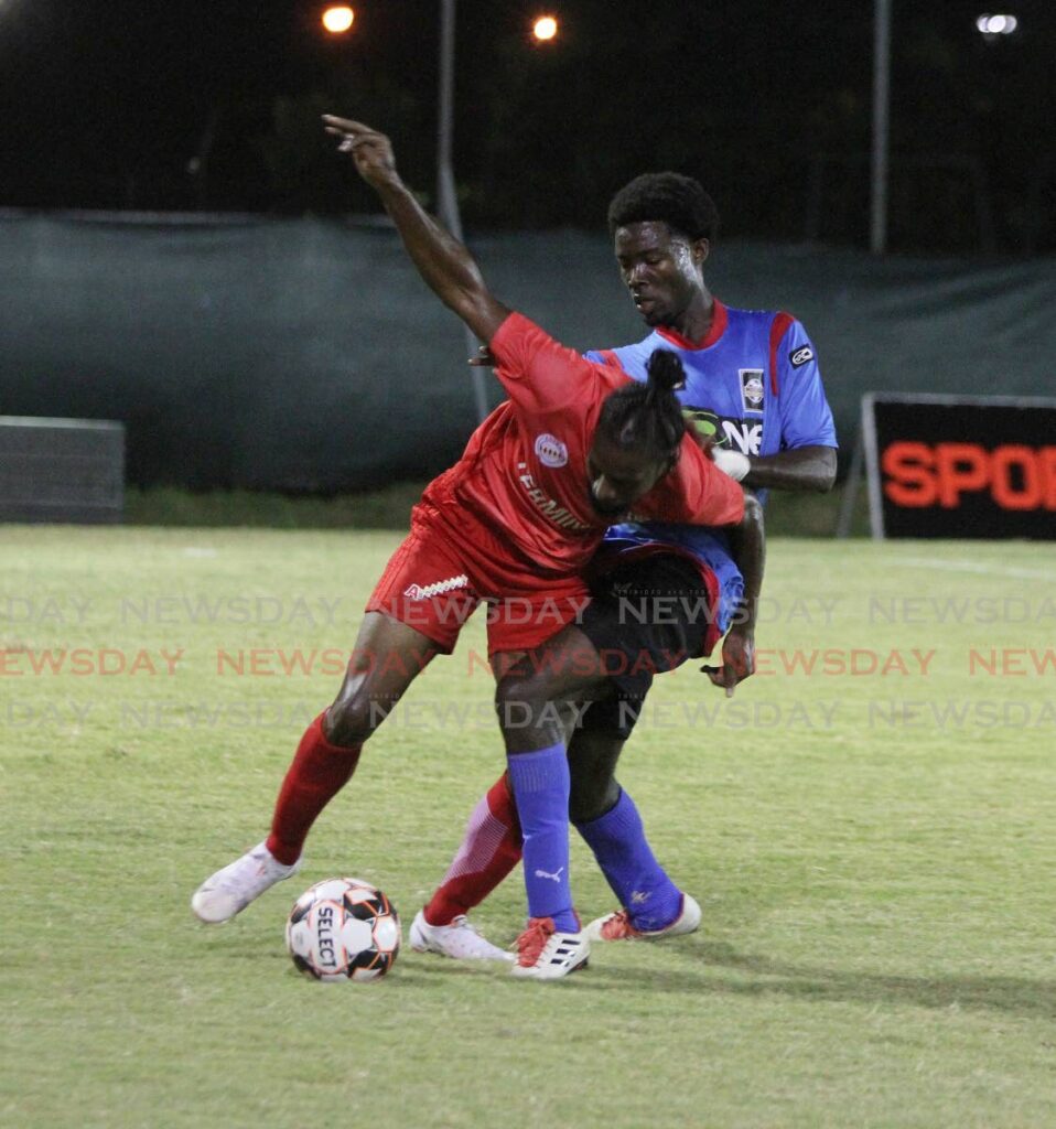 Junior Asson of Terminix La Horquetta Rangers (left), screens the ball from Henry Yahtham of Moruga FC, at the La Horquetta Recreation Ground, Arima on Friday. - Angelo Marcelle