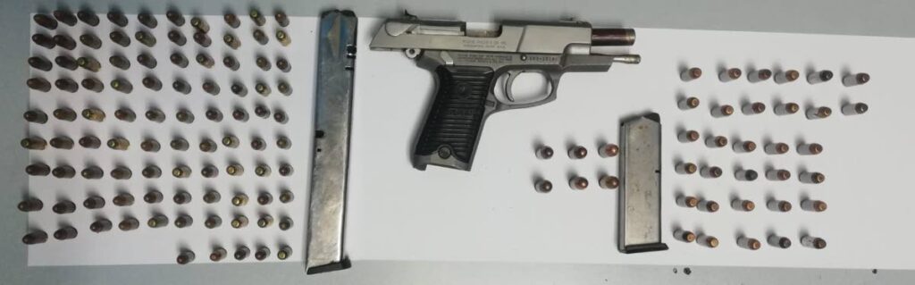 SEIZED: A firearm and a quantity of ammunition seized by police in an anti-crime exercise on the weekend. Police said that in the first ten days of April, 22 firearms were seized. PHOTO COURTESY TTPS - 