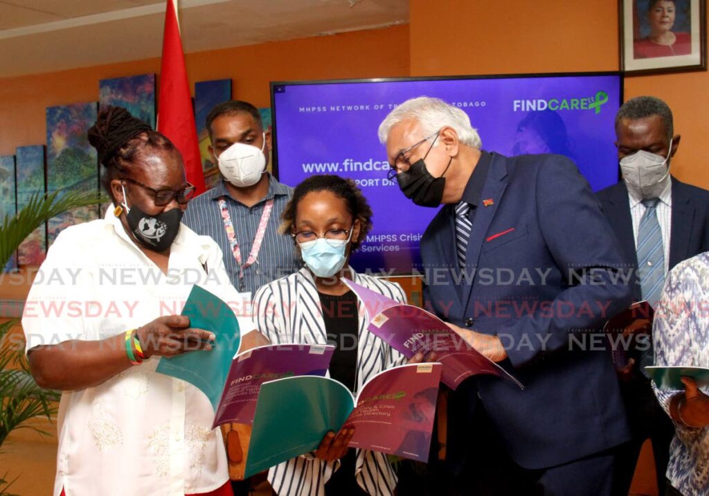 From left, President of GROOTS TT Delores Robinson, mental health planner Karline Brathwaite, and, Minister of Health Terrence Deyalsingh reads through mental heal documents during the Mental Health Find Care TT Stakeholder Engagement at the San Fernando Teaching Hospital, Monday. Photo by Ayanna Kinsale