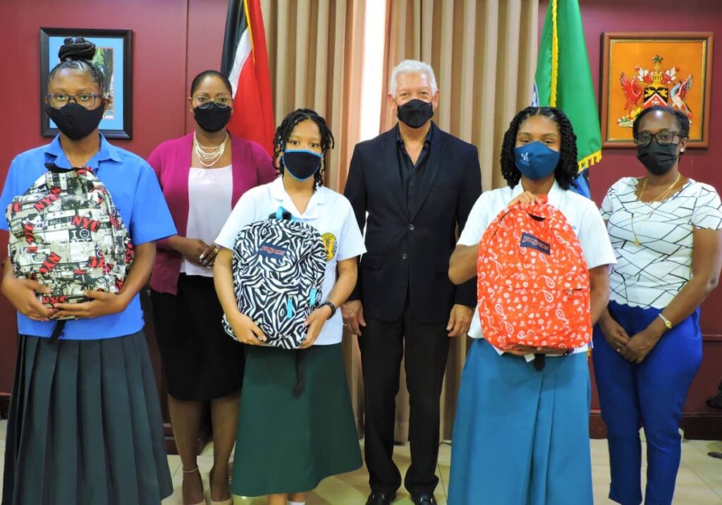 The top three students of the Mayor of Port of Spain's poetry writing competition pose with their prizes. In front row are winner Alyssa Philip of St Francois Girls' College, Belmont, centre; second placed Ariana Eustache, Providence Girls' Catholic School, Belmont, right; and third place Malaika Miggins of Tranquillity Government Secondary; mayor Joel Martinez, and councillors Nicole M Young (Belmont East) and Malouia Bourne (Belmont North West).  