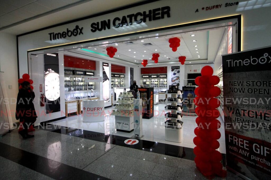 A traveller enters Timebox Suncatcher, the newest Dufry store at Piarco airport. - Angelo Marcelle