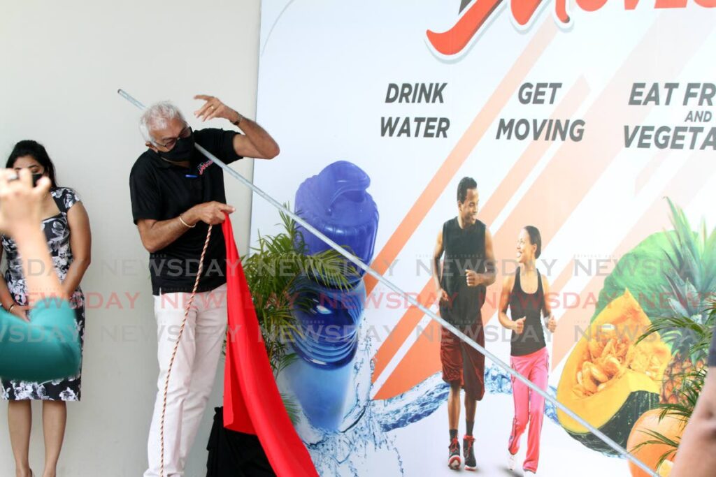 OOPS: Health Minister Terrence Deyalsingh is struck by a curtain rod during the unveiling of the TTMoves signage unveiling ceremony on Thursday at the Sangre Grande Enhanced Health Centre. PHOTO BY ANGELO MARCELLE - 