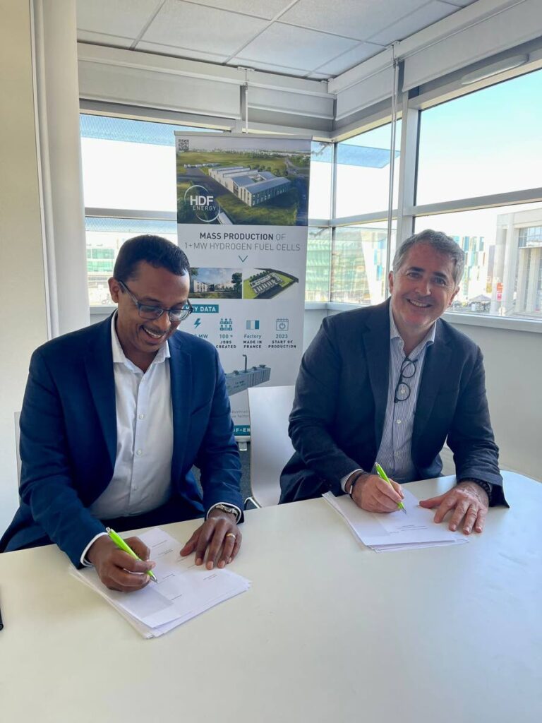 Kenesjay Green chairman Philip Julien signs the partnership agreement with chief executive of French-based HDF Energy, Damien Harvard, to develop the NewGen clean hydrogen producing facility in Trinidad. - Courtesy HDF Energy
