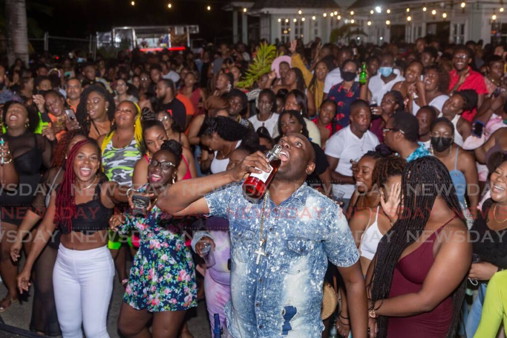 A soca lover takes a shot of liquor to the head during the Vibes with Voicey event at Fairways Restaurant and Golf Lounge, Lowlands, on April 14.  - David Reid
