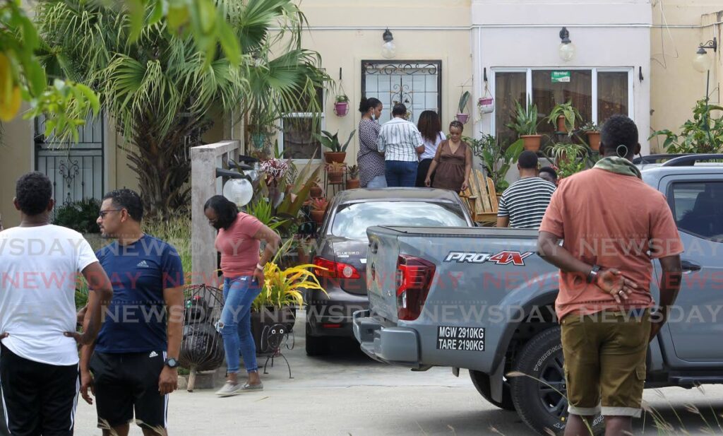 Realtives and friends gather outside the Chaguanas home of Kester Williams and Sharsa David after getting news of the tragic murder/suicide on Saturday. - ROGER JACOB