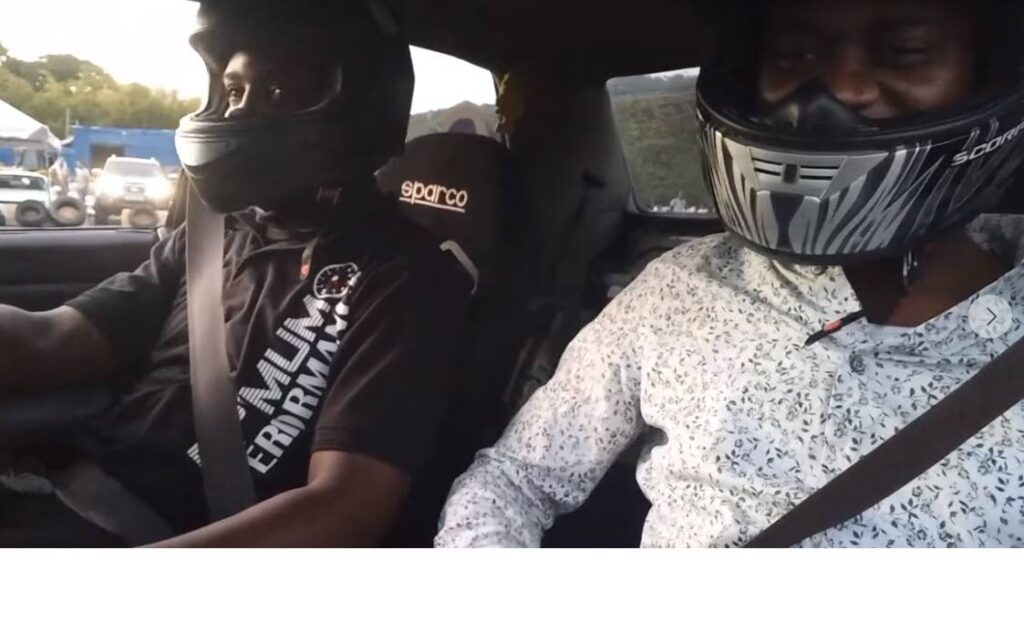 Chief Secretary Farley Augustine, right, enjoys a drifting experience courtesy driver Jaraad Stewart at Parade Grounds, Bacolet, Sunday. Courtesy Farley Augustine Facebook page - 