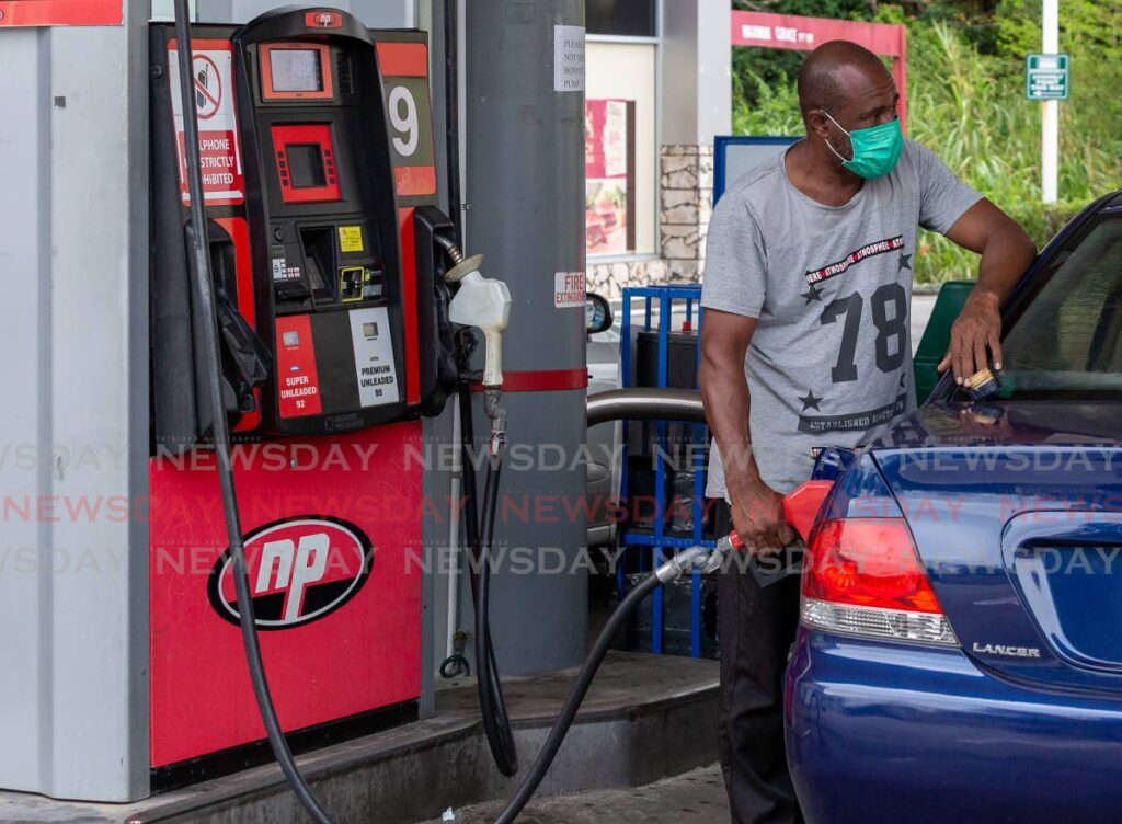 A man fills his tank with super gasoline at the Milford Gas Station, Bon Accord, Crown Point, Tuesday. - David Reid