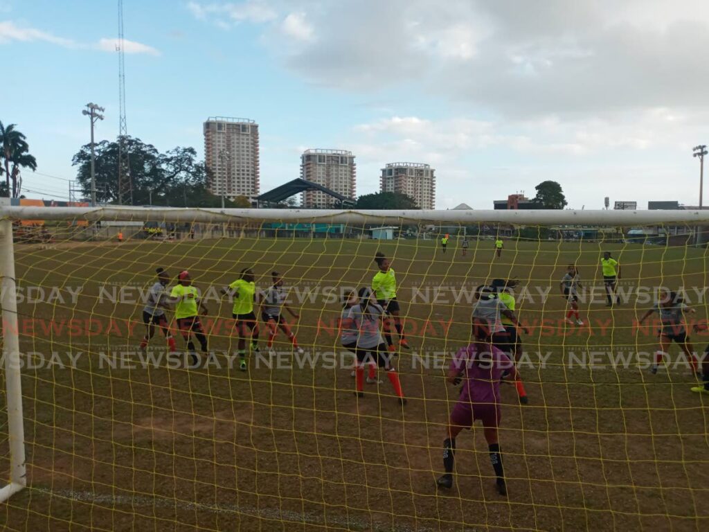 The national women's Under-17 team (grey) in a practice match against Police Women FC at the St James Police Barracks, on Tuesday.  - Jelani Beckles