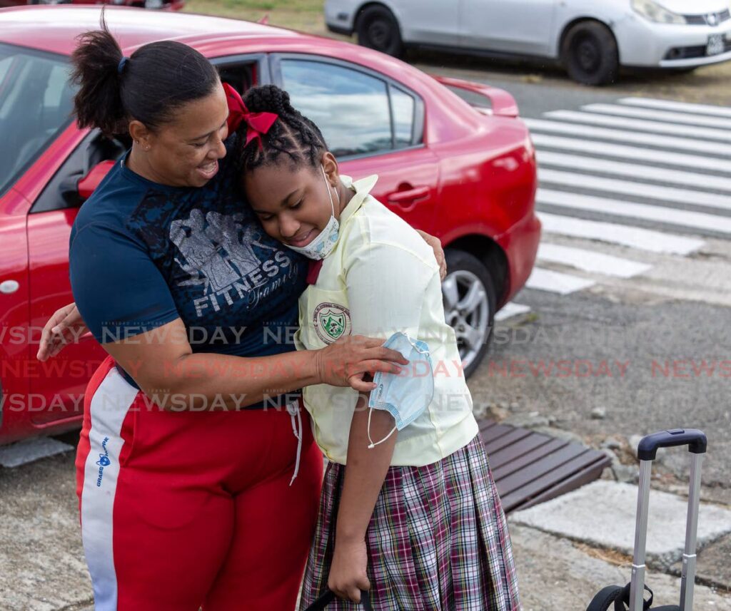 Signal Hill Government Primary School student Kimani Smith, 11, gets a hug from her mother Christine Smith before her first day of face-to-face classes on Wednesday. - David Reid