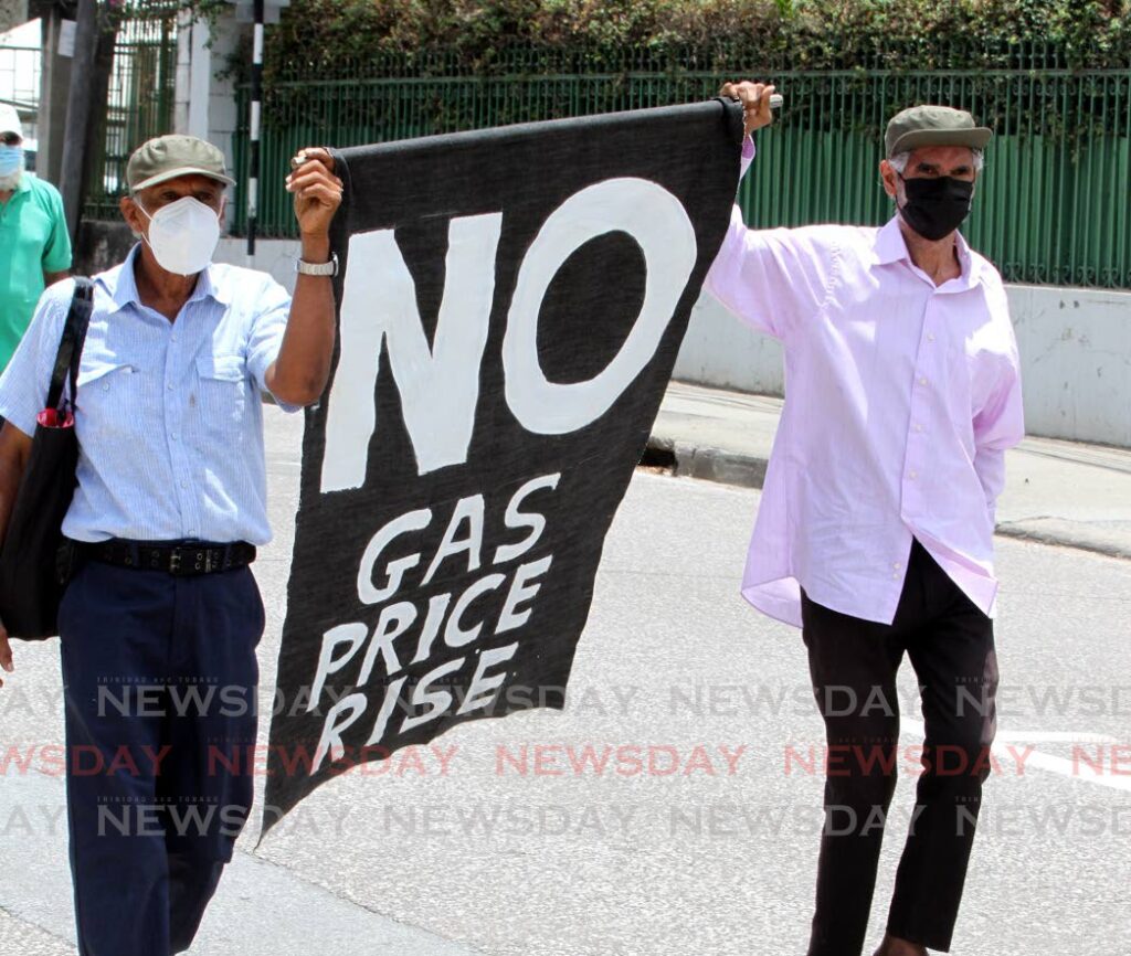 Activist Dr Wayne Kublalasingh, right, and Uresh Chaitoo joined the MSJ march against increased food and fuel prices in Port of Spain on Saturday.  - Angelo Marcelle