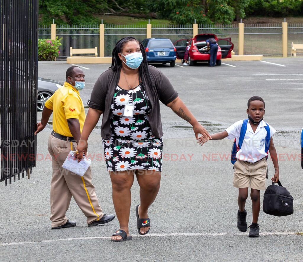 HOME TIME: Chrisse Winchester picks up her son Kenson Sterling, seven, after his first day at the Pentecostal Light and Life School in Scarborough on Monday. PHOTO BY DAVID REID - 