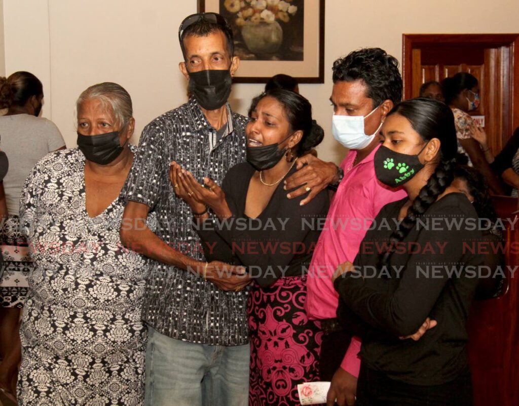 Marilyn Jagessar (third from left) grieves for her mother Sita Jagessar at her funeral on Wednesday at the JE Guide Funeral Home, San Fernando. - AYANNA KINSALE