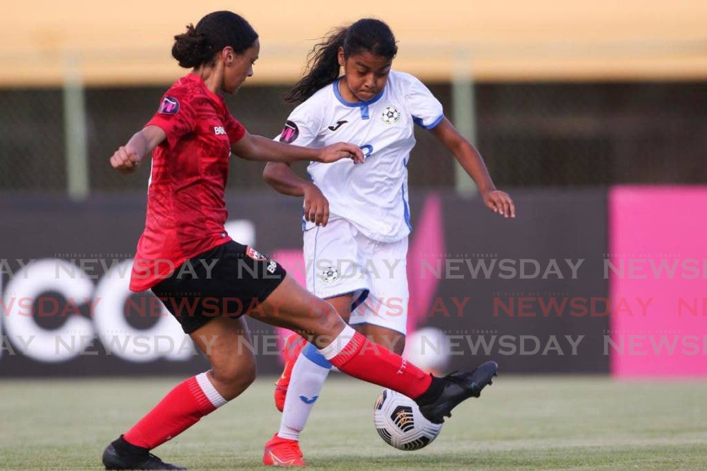 A Trinidad and Tobago player tackles her Nicaraguan opponent in a Concacaf Under 17 Women's Championship match. Photo courtesy Concacaf  - 