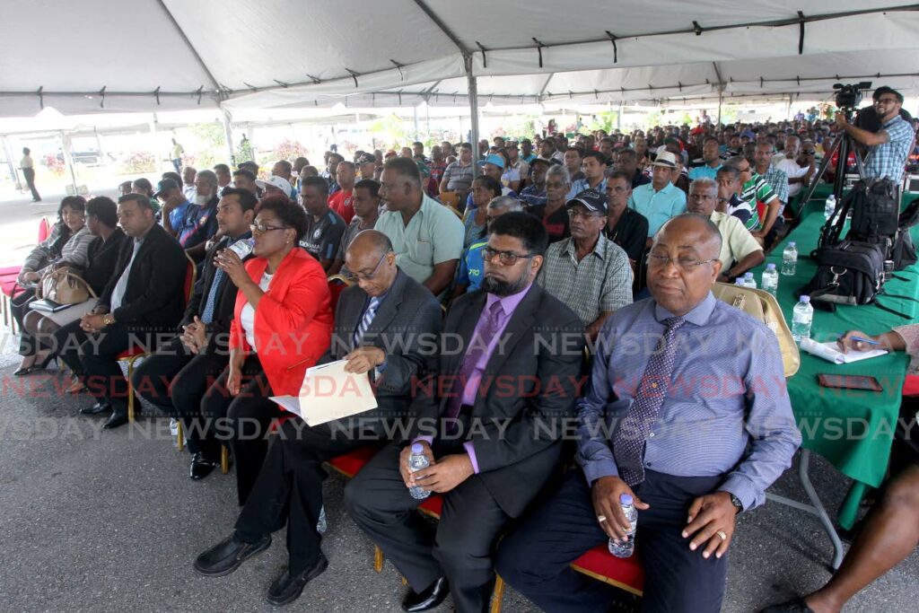 Former Caroni 1975 Ltd workers gather to receive residential and agricultural leases during a distribution ceremony in 2018. - File photo/Lincoln Holder