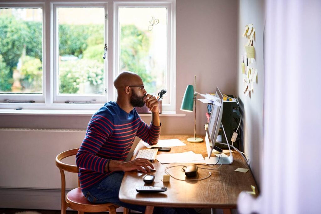A typical sence of someone working on a computer at home.  - Photo taken from www.thebalancecareers.com