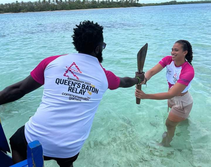 Trinidad and Tobago runner Sherridan Kirk passes the Queen's Baton to national swimmer Ornella Walker at the Nylon Pool on Thursday. Image source: Team TTO Facebook Page