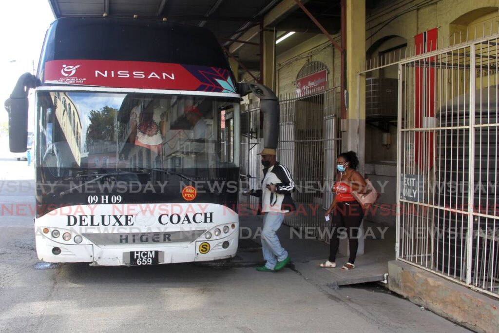 Commuters board a PTSC bus on the San Fernando to Port of Spain route at the King’s Wharf terminal in San Fernando. -Photo by Lincoln Holder