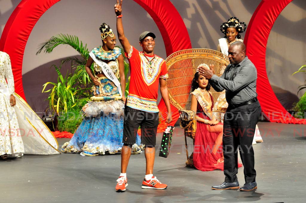 Gregor Breedy raises his hand in the air after being announced as the winner of the Best Choreographer award for his work with the North West Laventille Cultural Movement in 2017. 