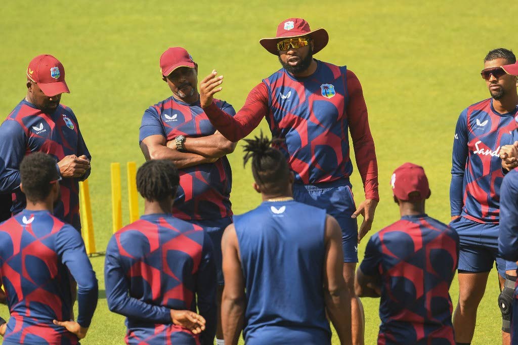 In this February 14 file photo, West Indies’ cricket captain Kieron Pollard (C) speaks with teammates during a training session ahead of their first of three T20 matches against India at the Eden Gardens in Kolkata. - 