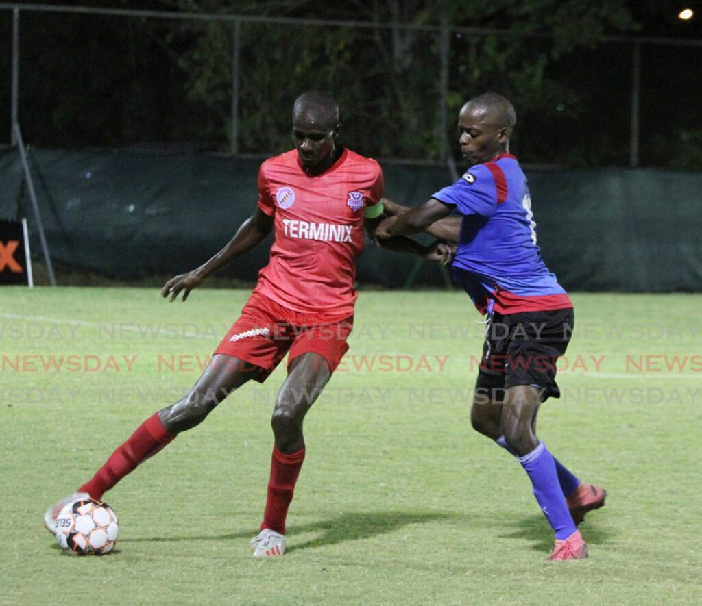 Captain Jamal Craighton of Terminix La Horquetta Rangers (left), screens the ball from Atiba Charles of Moruga Football club, during a match at the La Horquetta Recreation Ground, Arima on April 8. Photo by Angelo Marcelle