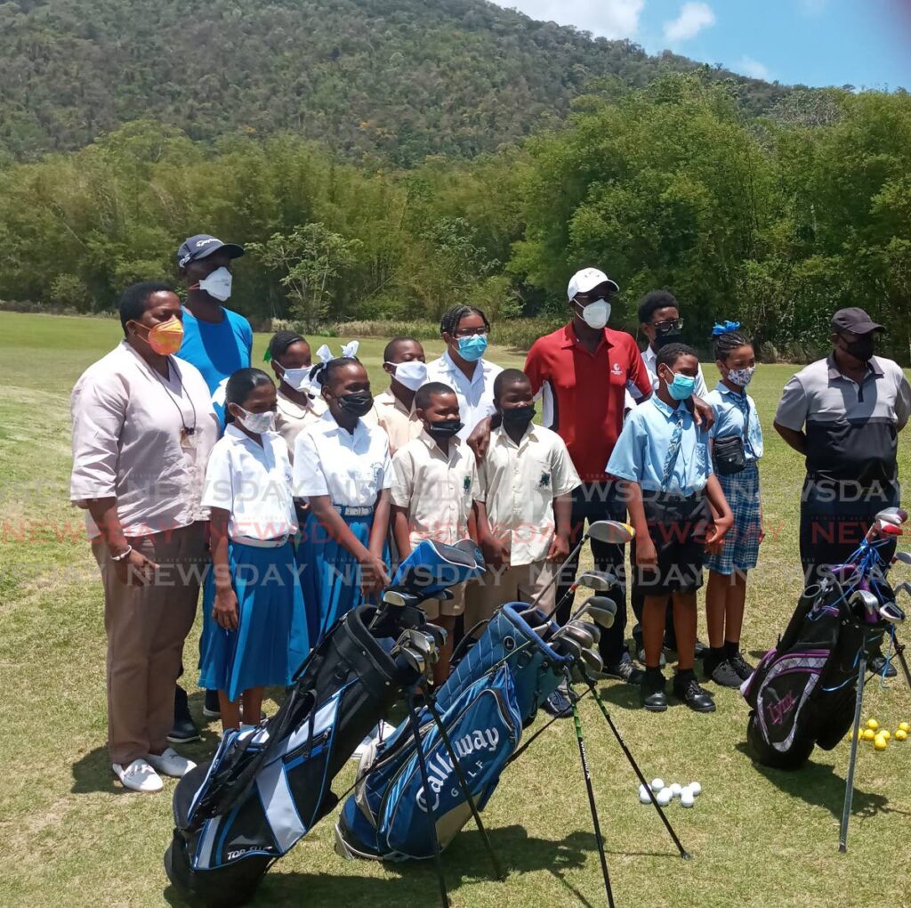Prime Minister Dr Keith Rowley (red t-shirt) and Minister of Planning and Development Pennelope Beckles, (left), alongside students and golf coaches at the launch of the Chaguaramas Development Authority 2022 Junior Golf programme at Chaguaramas Golf Course, on Wednesday. Photo by Jelani Beckles