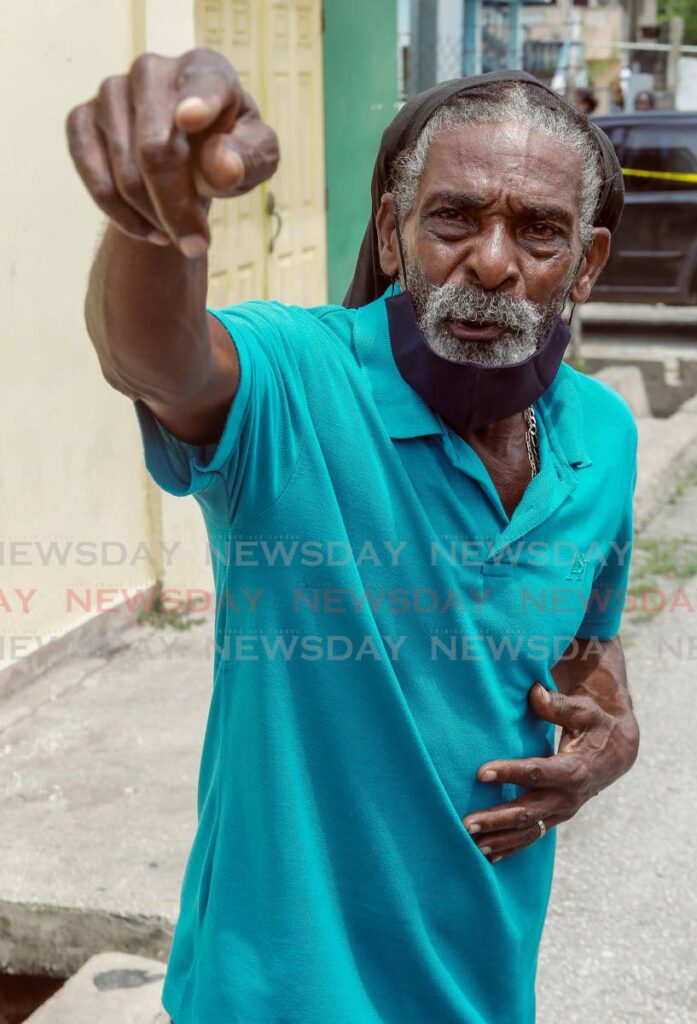 Leo Hilaire, father of murdered cable technician Shamal Hilaire, speaks at the scene of his son's death at Ste Madeleine Circular Road, Ste Madeleine on Thursday. Photo by Lincoln Holder