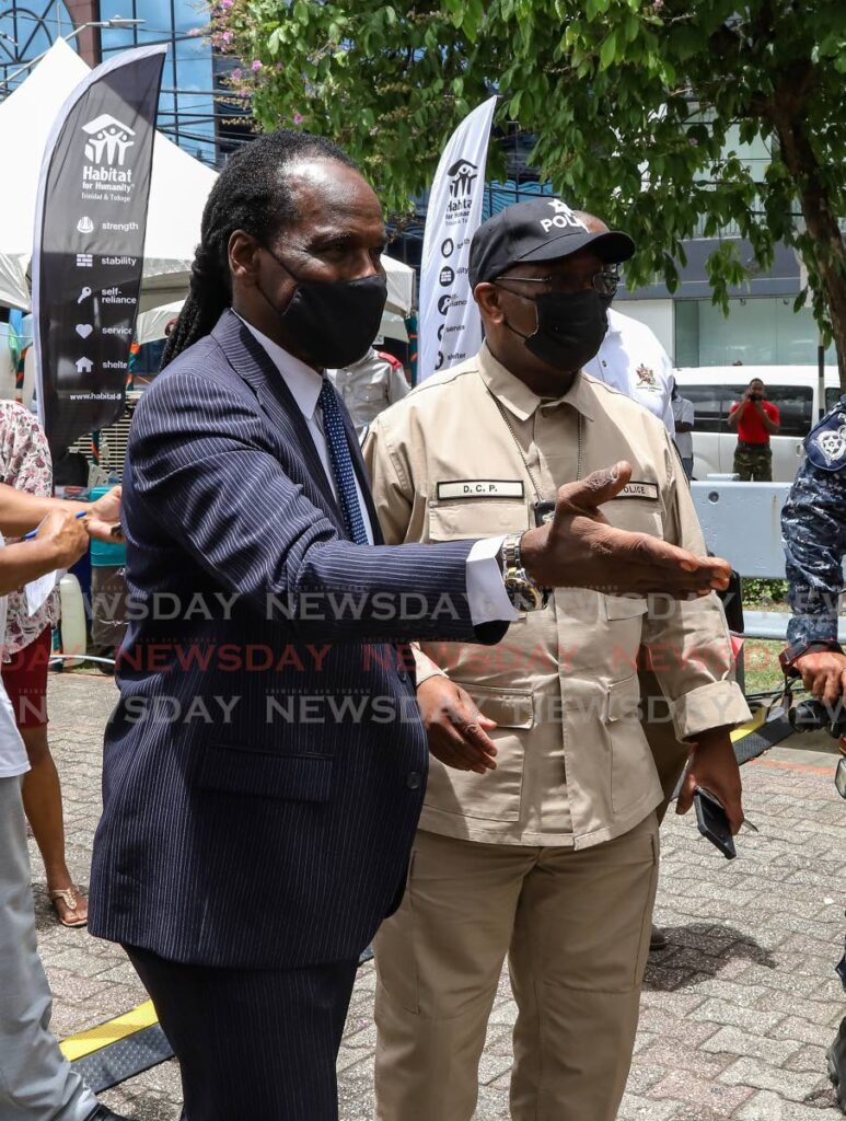 Minister of National Security Fitzgerald Hinds and CoP (Ag.) McDonald Jacob tour the Brian Lara Promenade during the National Disaster prevention and preparedness month caravan on Friday. - JEFF K MAYERS