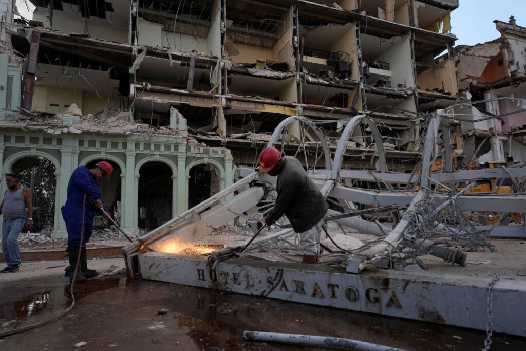 Workers remove debris from the site of Friday's deadly explosion that destroyed the five-star Hotel Saratoga, in Havana, Cuba on Saturday. - AP Photo