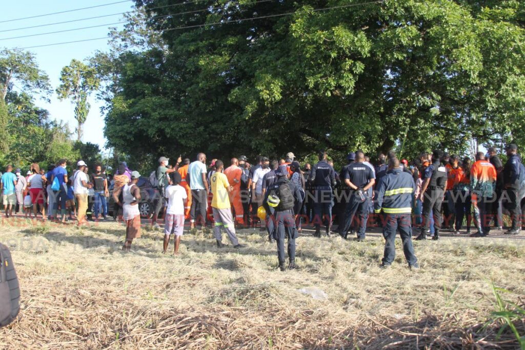 Police officers, fire officers, hunters and villagers gather to begin their search for two-year-old Kimani Francis in Point Fortin on Monday. Photo by Marvin Hamilton